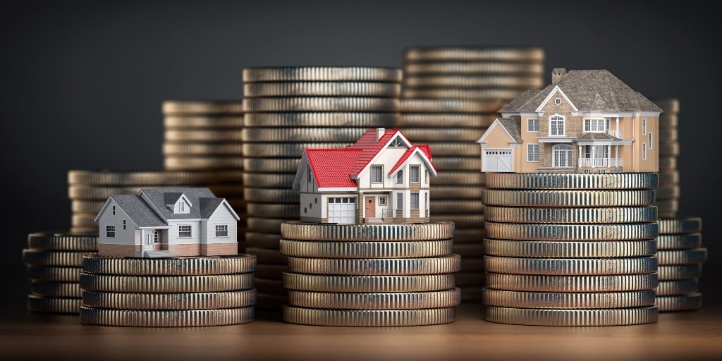 Miniature houses on top of coins