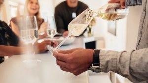 Man serving a wines to friends